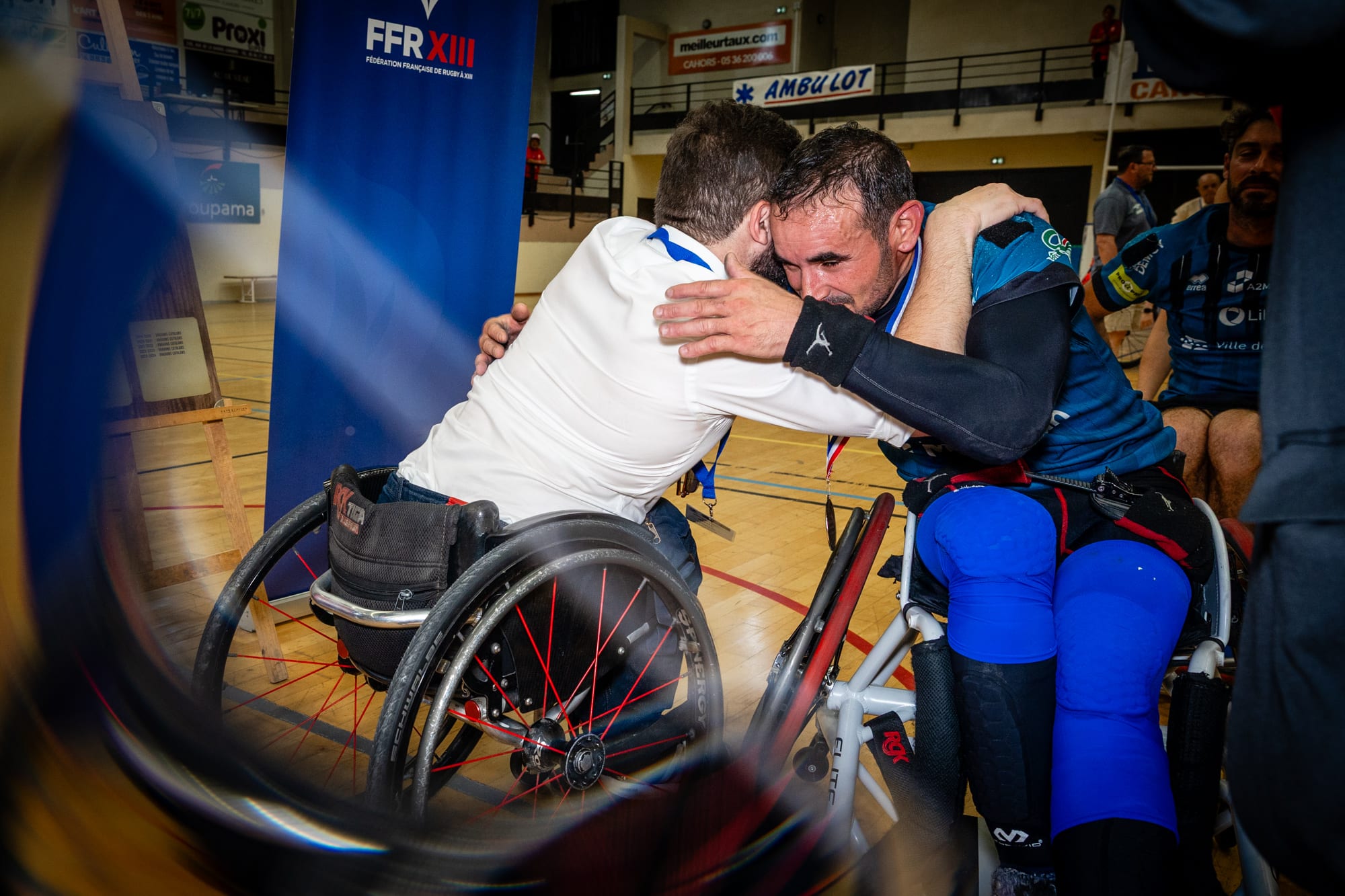Émotion après la finale de para rugby — accolade entre joueurs devant le logo FFR XIII à Cahors